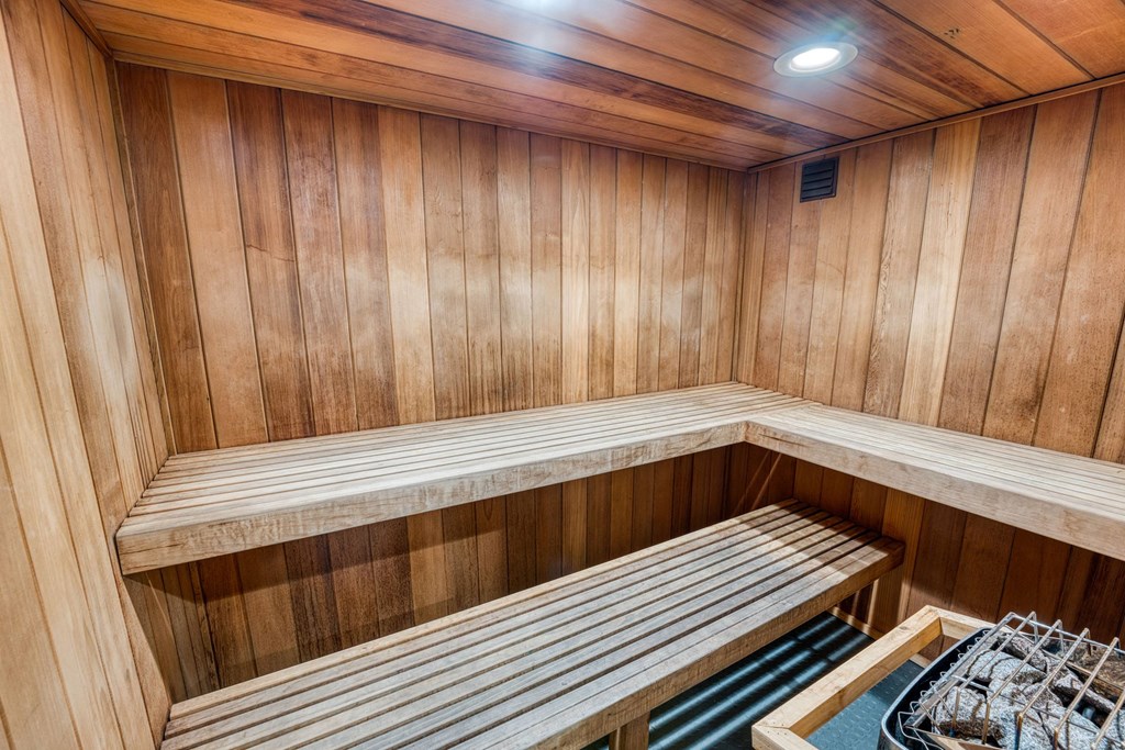 a sauna with wooden walls and wooden benches at Juniper Springs Apartments, Austin, TX